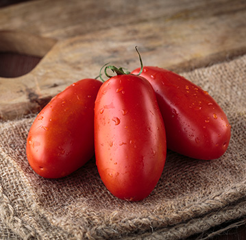 san marzano tomatoes on a wooden board